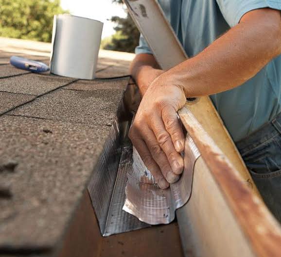 Technician repairing a gutter